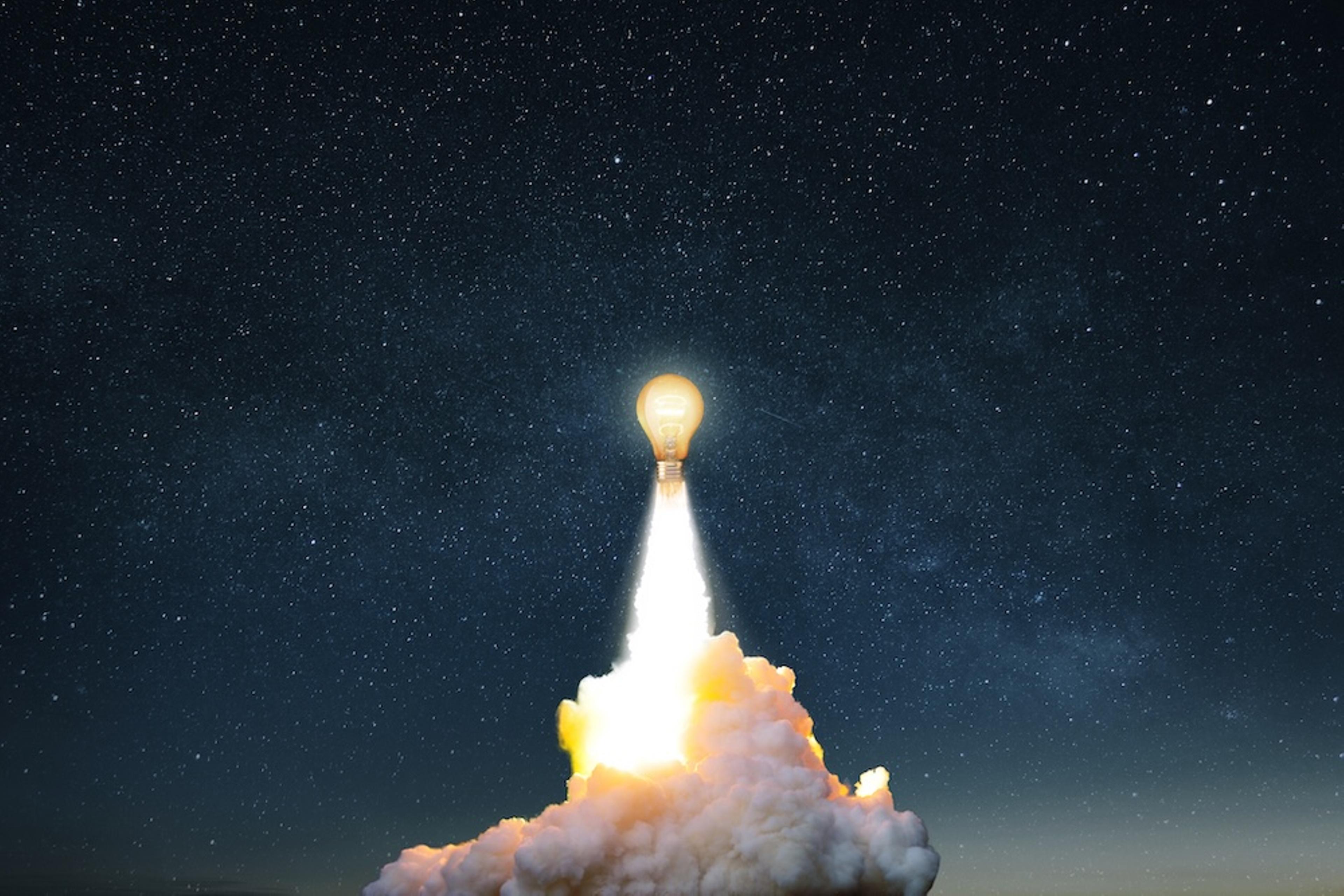 a lightbulb-rocket taking off against a night sky producing a cloud of smoke and exhaust